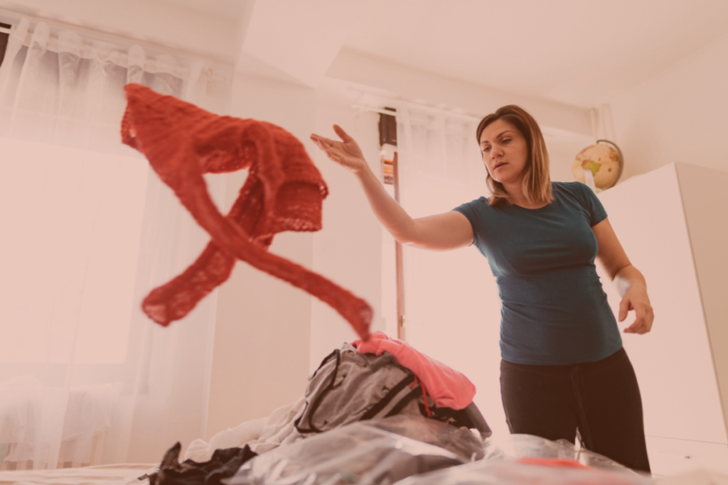 Frustrated Midlife woman tossing clothes on bed Cindy Blakely at MsBStyling.com