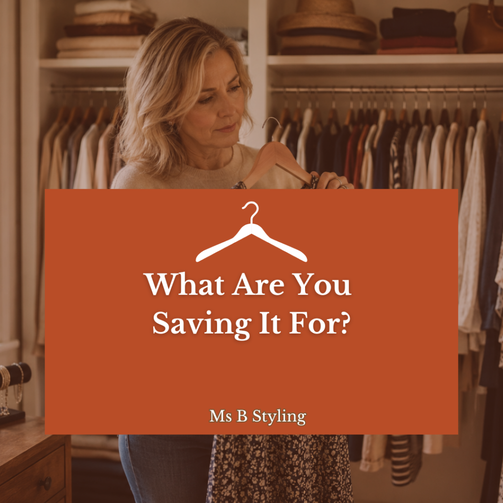 woman holding dress in closet